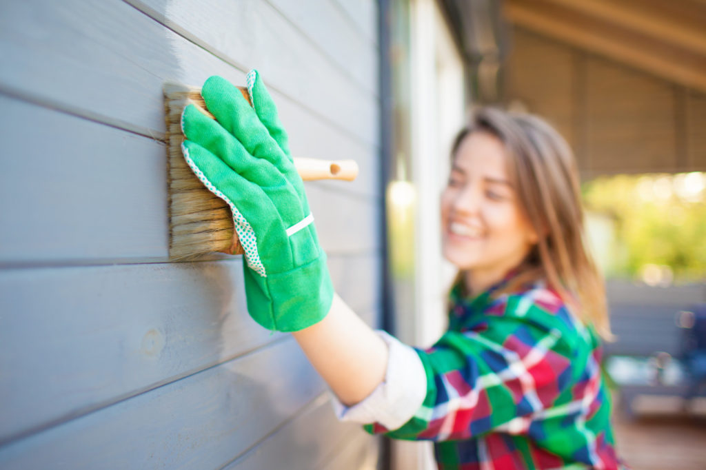 woman painting a house